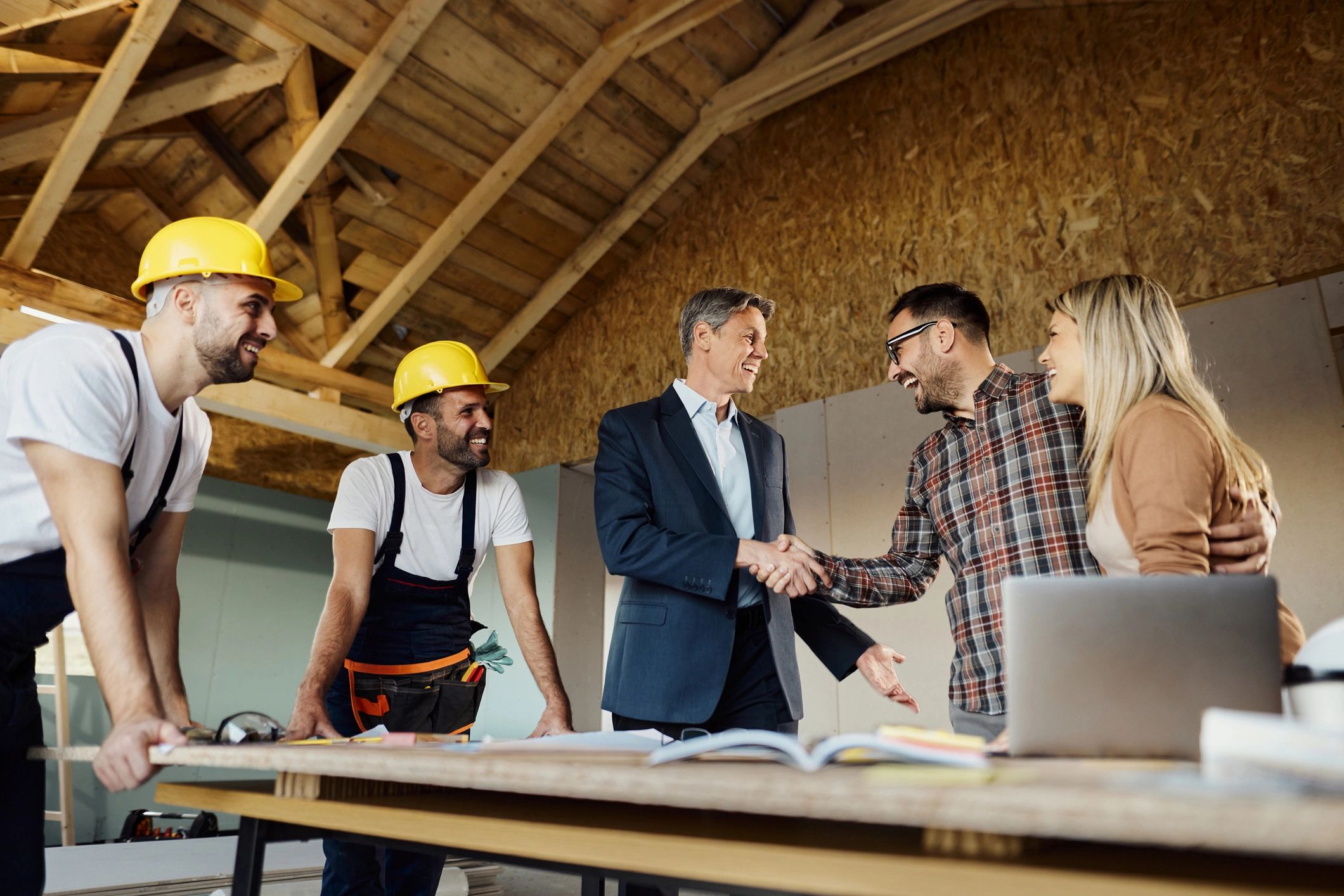 Two contractors shaking hands — trusted professional referral.
